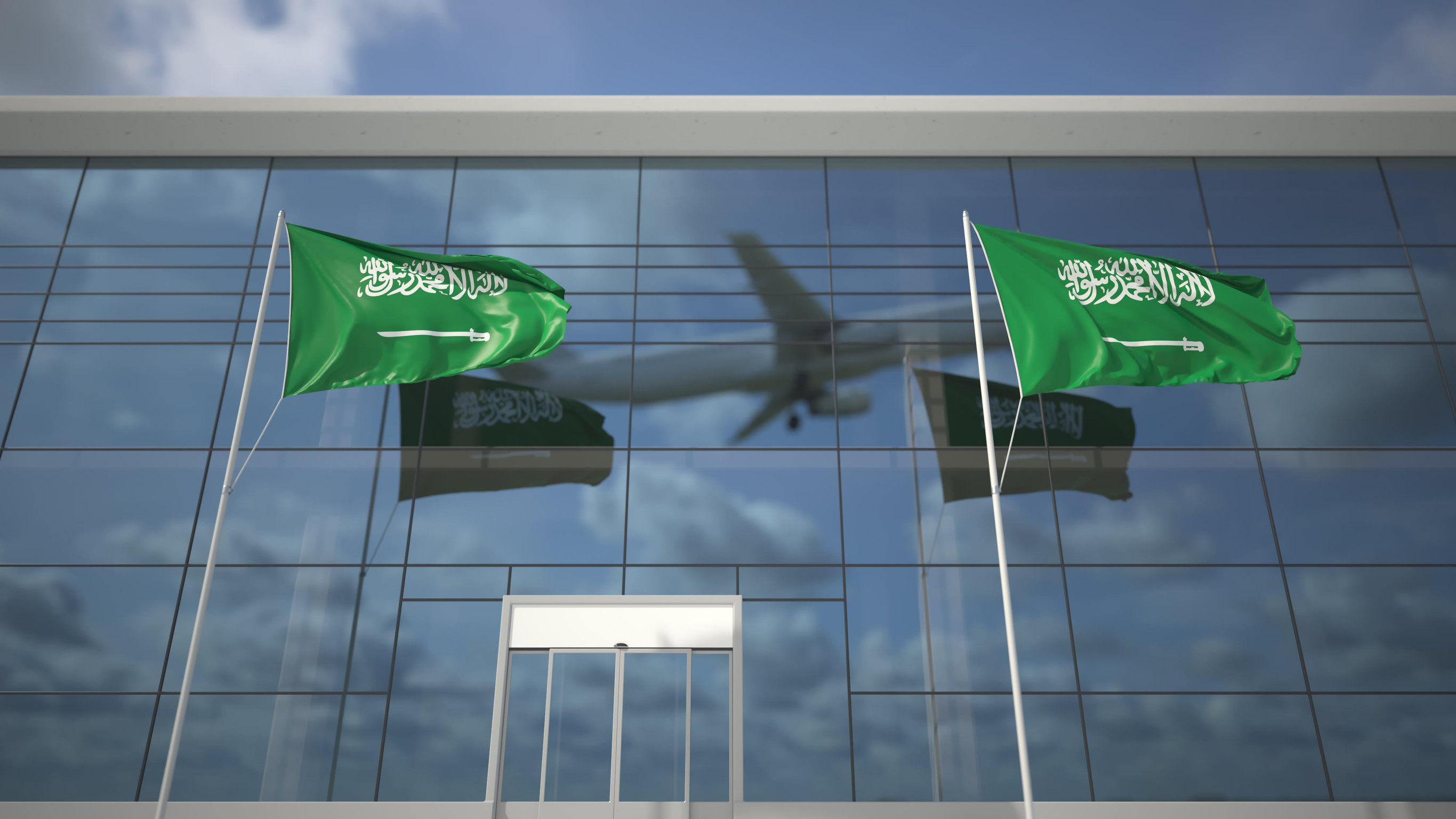 Aeroplane reflected behind Saudi flags