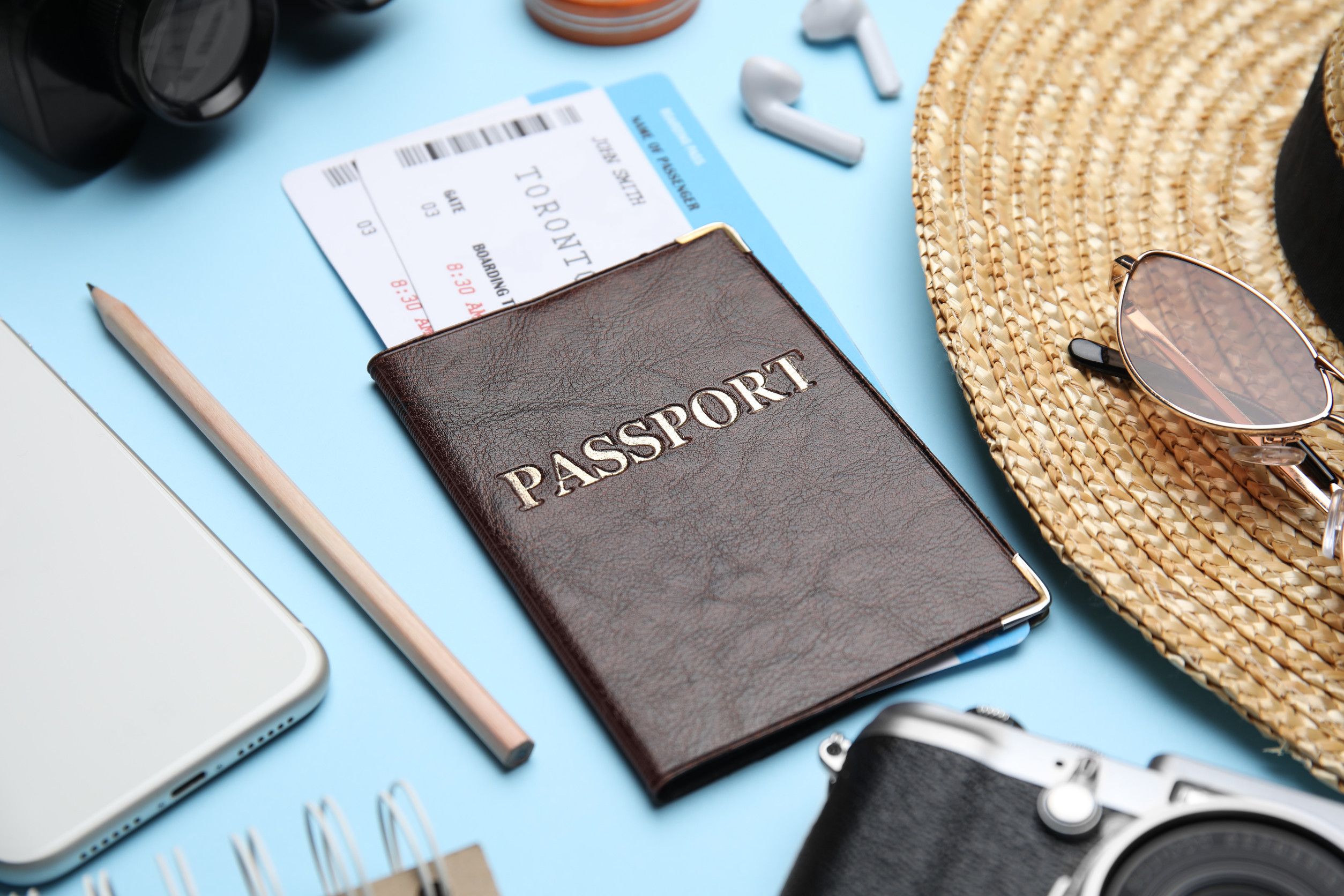 Passport with travel essentials laid out