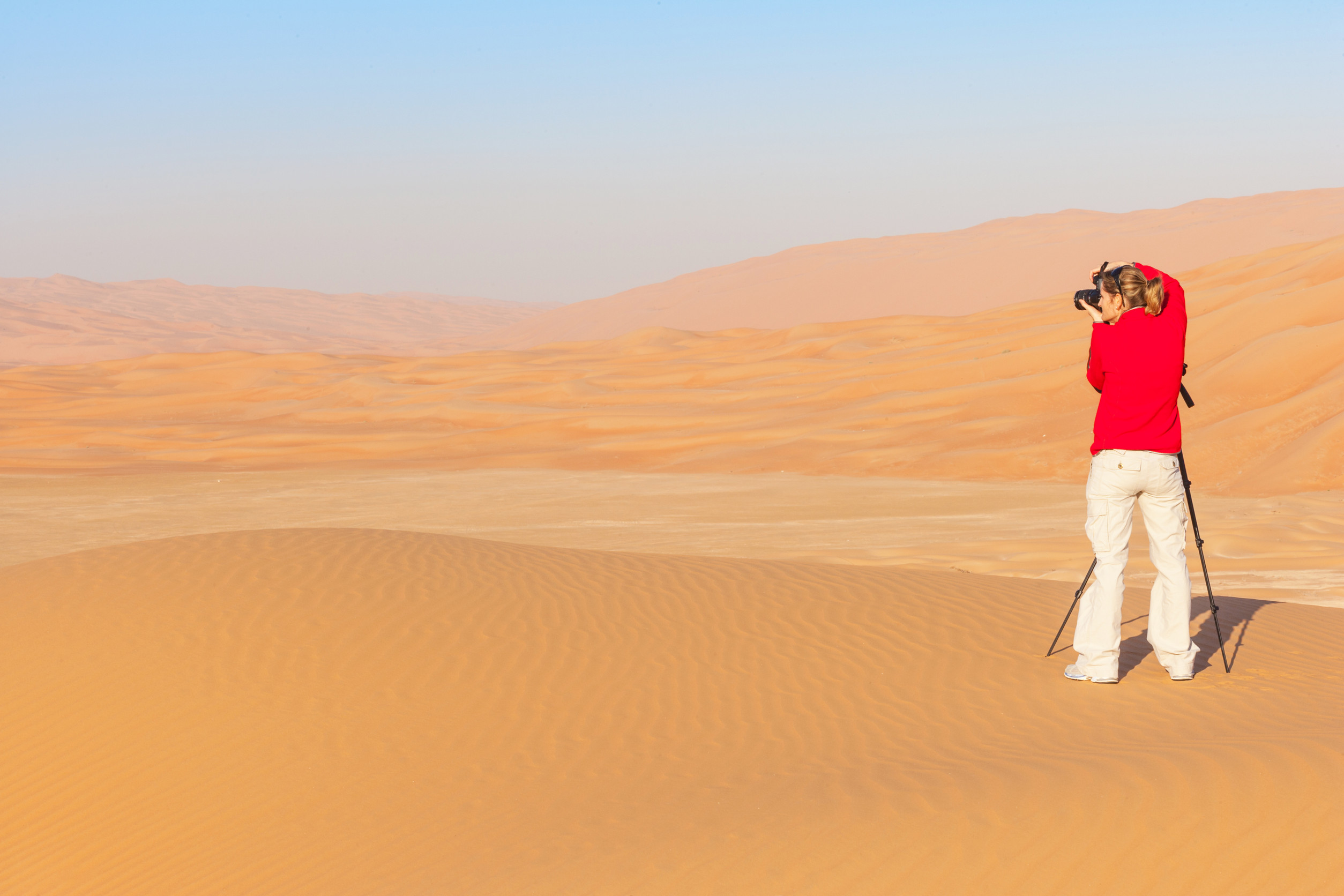 Woman Photographing Sand Dunes In The Rub Al Khali Or Empty Quarter Straddling Oman Saudi Arabia